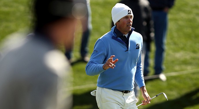 Matt Kuchar (right) reacts after he hit a chip shot onto the green as Hunter Mahan stands in the foreground during the final round of the WGC-Accenture Match Play Championship.