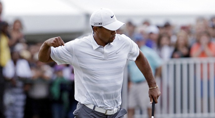 Tiger Woods celebrates a birdie on No. 18 during the third round of the WGC-Cadillac Championship.