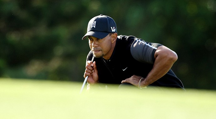 Tiger Woods looks over his putt at No. 15 in Round 1 of the Arnold Palmer Invitational.