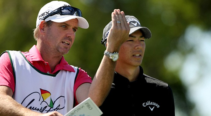 Ryo Ishikawa with his caddie at No. 7 in Round 1 of the Arnold Palmer Invitational.
