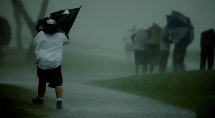 Spectators take cover during the final round at Arnold Palmer Invitational at Bay Hill.