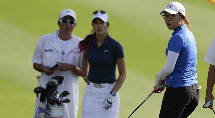Lydia Ko (right) and Michelle Wie wait to hit on the 11th hole during the first round of the LPGA Kraft Nabisco Championship.