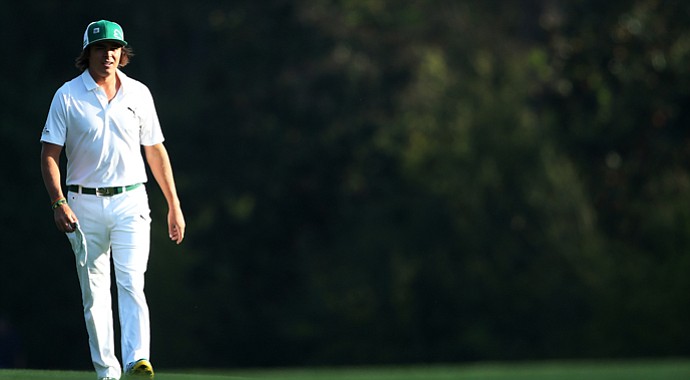 Rickie Fowler walks along a fairway during a practice round prior to the start of the 2013 Masters.
