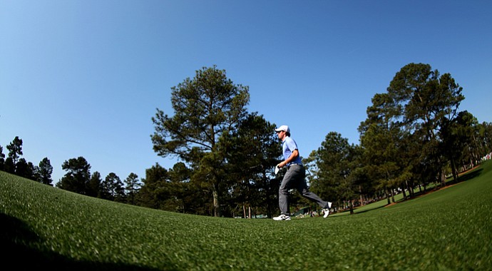 Rory McIlroy walks up a fairway during a practice round prior to the start of the 2013 Masters.