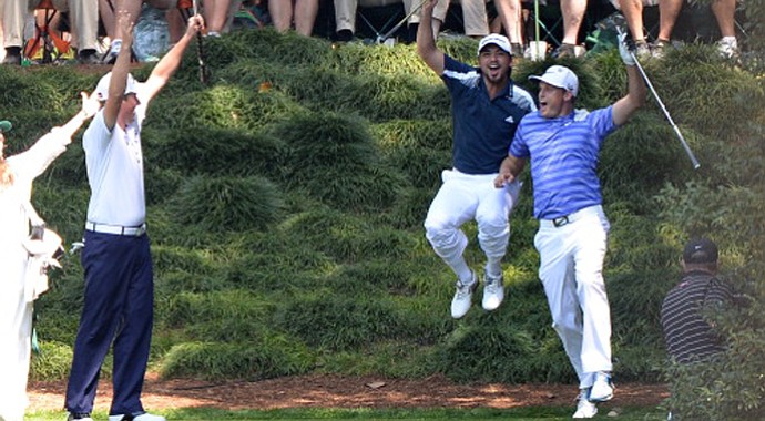Nick Watney celebrates with Jason Day and Webb Simpson after getting a hole in one on the ninth hole during the Par-3 Contest at Augusta National.
