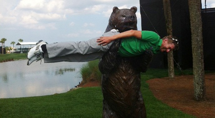 David Lynn does a little "planking" in the arms of a bear.