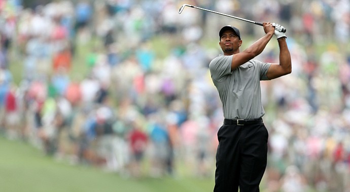 Tiger Woods hits a shot on the first hole during the first round of the 2013 Masters.