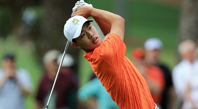 Tianlang Guan hits a shot on the first hole during the second round of the 2013 Masters.