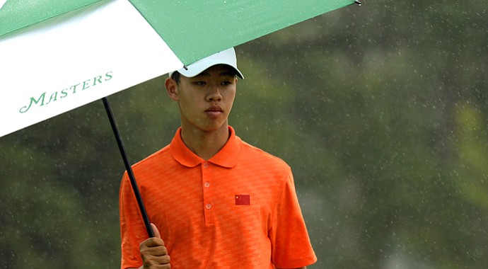 Tianlang Guan plays in the rain during the second round of the 77th Masters.