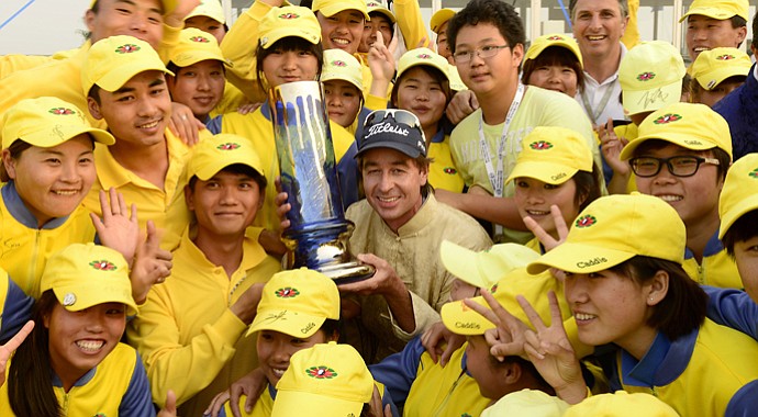 Brett Rumford, center, with the winner's trophy is surrounded by tournament volunteers after he won the China Open on Sunday.