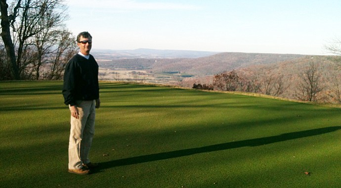 Matt Daniels, Sewanee's head professional, shares the legend of 'Shakerag Hollow' while admiring the view northward from the Gil Hanse-renovated course, which reopens in early June.