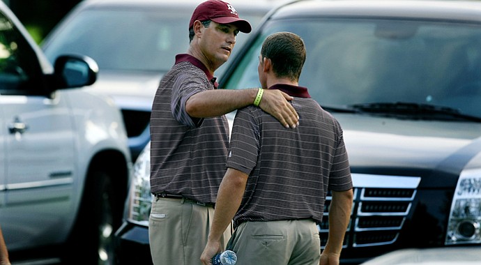Texas A&M head coach J. T. Higgins talks with Tyler Dunlap after they were eliminated in a playoff during the final round of stroke play of the 2013 NCAA Championship.