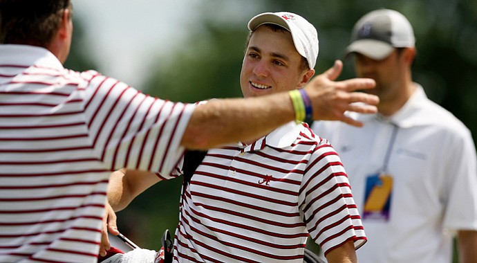 Head coach Jay Seawell greets Justin Thomas with a great big hug after Thomas closed out his match against Seth Reeves of Georgia Tech during the semifinals of match play at the 2013 NCAA Championship. Alabama will face Illinois in the final.