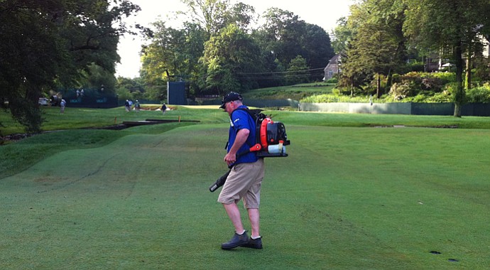 Volunteer groundskeeper Charlie Carr blow-dries the 11th fairway at Merion Golf Club on Tuesday before the U.S. Open.