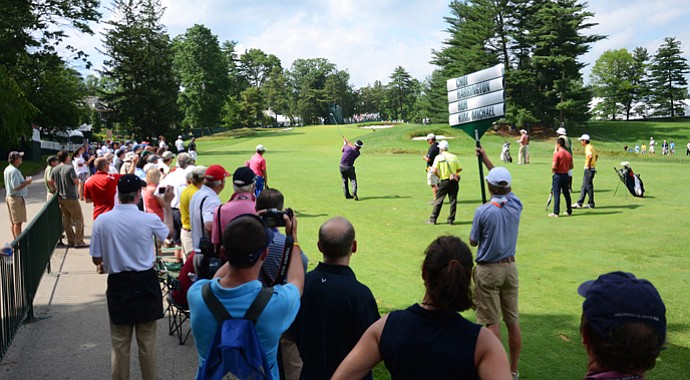 K.J. Choi hits from the left side of the fairway on the 15th hole. Fans, who are all out of bounds, line the left side, only eight feet from the fairway.