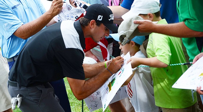 Max Homa stops to sign autographs after finishing his 13th hole in a practice round on Wednesday at the U.S. Open.