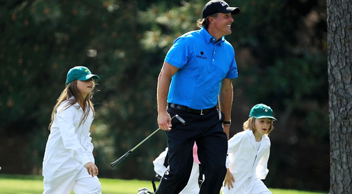 Phil Mickelson walks with his daughter Amanda (left) during the Par 3 Contest prior to the 2010 Masters.