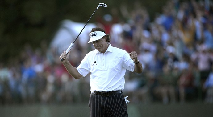 Phil Mickelson reacts to his birdie putt on the 18th green to card a 2-over 72 and is tied for the U.S. Open lead at 1 under.