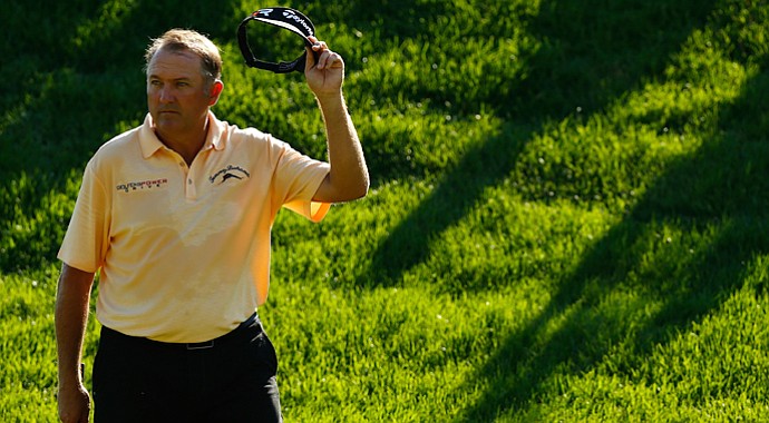 Ken Duke acknowledges the crowd as he walks onto the 18th green during the final round of the Travelers Championship.