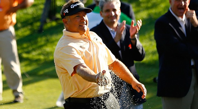 Ken Duke celebrates by spraying Coca-Cola all over the 18th green after winning the Travelers Championship.