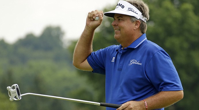 Kenny Perry celebrates after sinking a par putt on the 18th green during the final round of the Senior Players Championship.