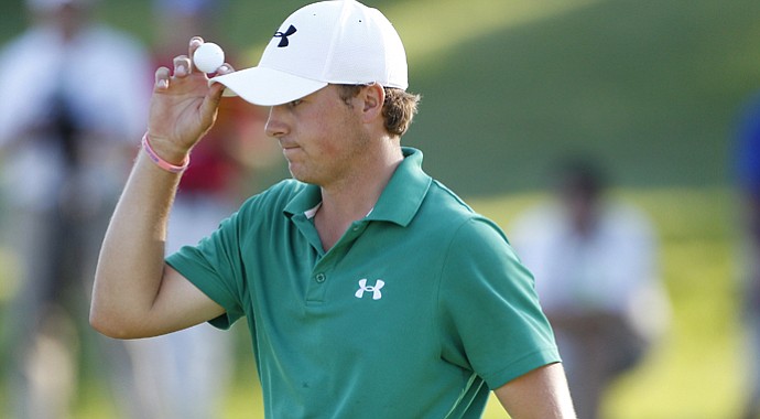Jordan Spieth holds up his ball during a playoff after the final round of the John Deere Classic.