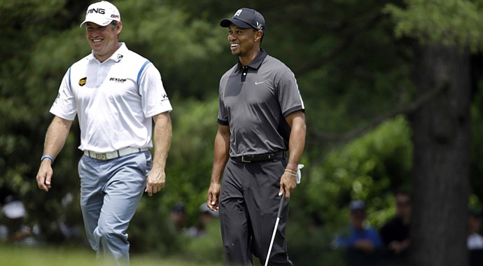 Lee Westwood (left) has joined Tiger Woods (right) as a client of coach Sean Foley.