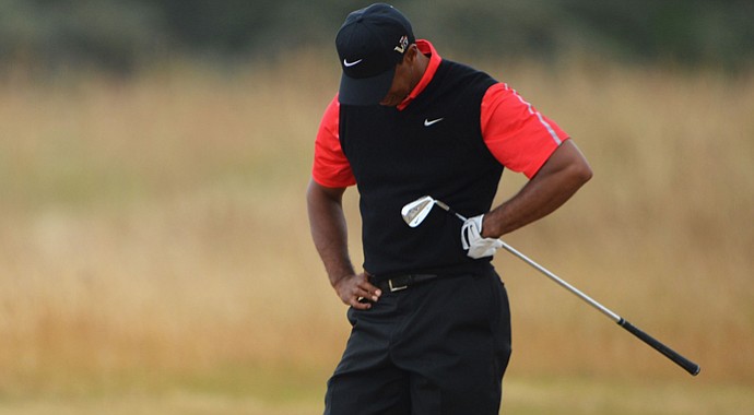 Tiger Woods was caught by microphones offering up a couple of cuss words after a poor shot early in his round.