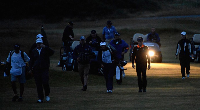 Bernhard Langer and Mark Wiebe make their way onto the 18th green for the second playoff hole during the final round of the Senior Open Championship at Royal Birkdale.