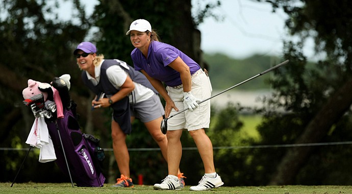 Dawn Woodard, right, watches a shot on Monday with caddie and friend Kelley Hester.