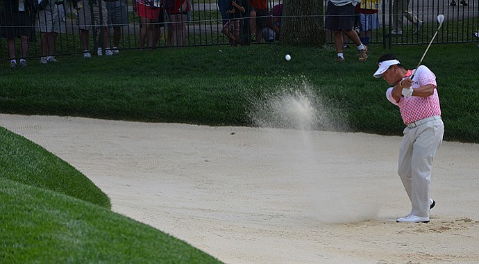 K.J. Choi practices bunker shots prior to the start of the 95th PGA Championship at Oak Hill.