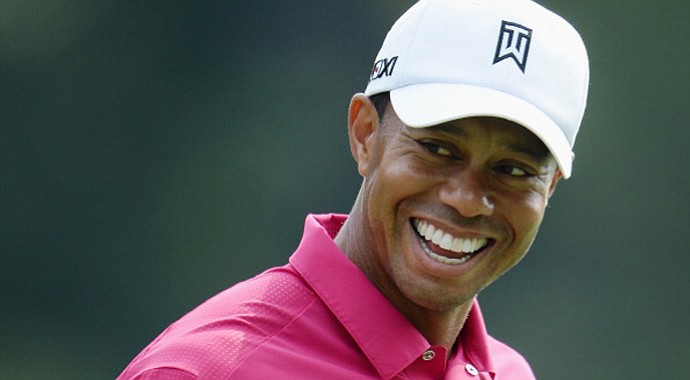 Tiger Woods smiles during a practice round prior to the start of the 95th PGA Championship at Oak Hill Country Club.