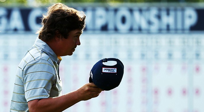 Jason Dufner walks off the 18th green after shooting a 7-under 63 during the second round of the 95th PGA Championship.