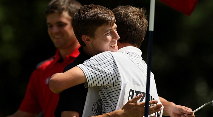 Matthew Fitzpatrick gets a hug from his brother/caddie Alex after they defeated Corey Conners during the semifinals at the 2013 U. S. Amateur at The Country Club.