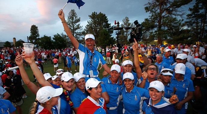 Members of the European team hold Captain Liselotte Neumann on their shoulders as they celebrate defeating the United States 18-10 in the 2013 Solheim Cup.