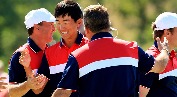 Michael Kim and his U.S. teammates celebrate after Kim and partner Max Homa came back to win 1 up in morning foursomes action at the Walker Cup.