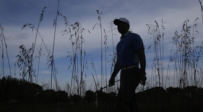 Tiger Woods is silhouetted as he walks the course during the pro-am round of the 2013 BMW Championship. It was his first – and only – practice round in preparation for this week's tournament.