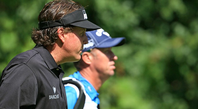 Phil Mickelson walks up the second fairway with caddie Jim Mackay during the first round of the BMW Championship at Conway Farms.