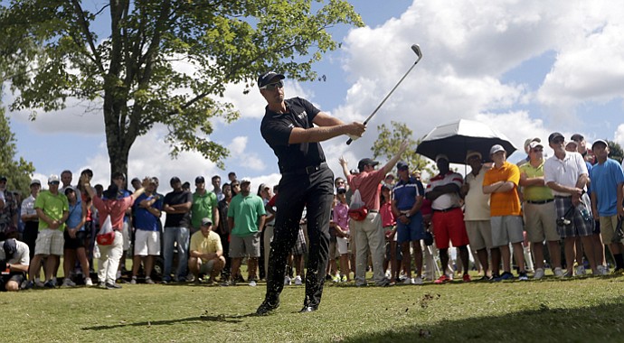Henrik Stenson hits out of the rough on the first hole during the final round of play in the Tour Championship.