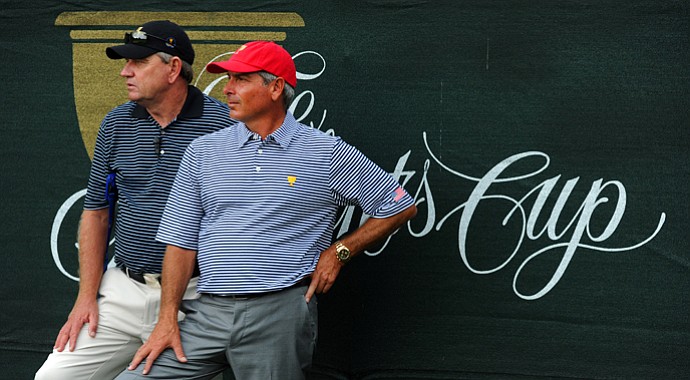 Nick Price, captain of the International team, and Fred Couples, captain of the U.S. team, watch the action on 7th hole during the Day 2 foursome matches at Muirfield Village.