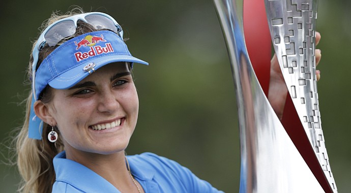 Lexi Thompson holds the trophy after winning the LPGA Malaysia in Kuala Lumpur on Sunday.