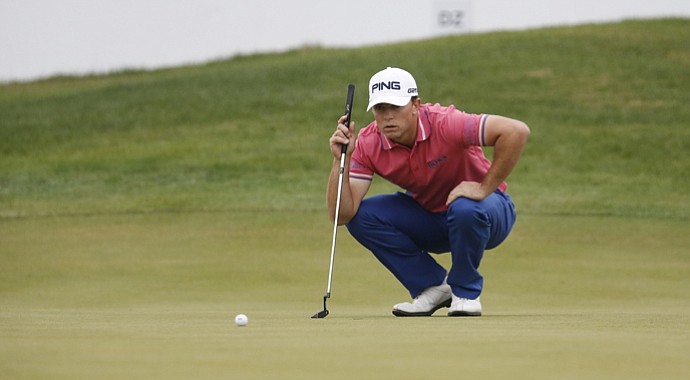 Luke Guthrie reads his putt on the 18th green during the second round of the BMW Masters. Guthrie leads by four shots.