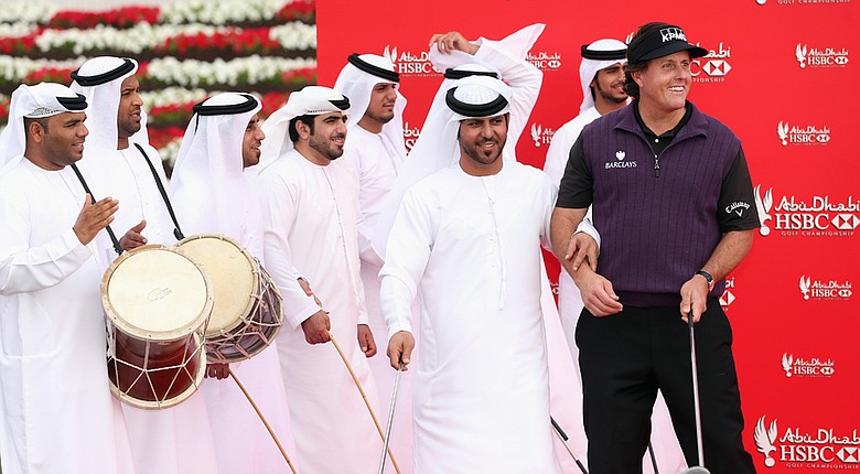 Phil Mickelson with local dancers during a photo call prior to the start of the Abu Dhabi HSBC Championship.