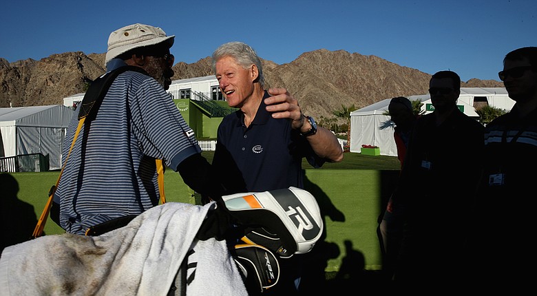 Former U.S. President Bill Clinton greets attendants of the Humana Challenge in partnership with the Clinton Foundation before the first round at PGA West in La Quinta, California.