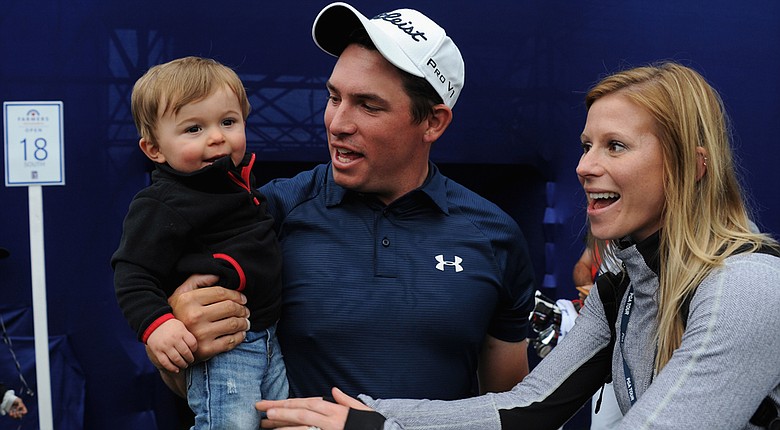 Scott Stallings meets his wife, Jennifer, and his son, Finn, on the 18th hole after winning the Farmers Insurance Open on Torrey Pines South.