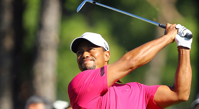 Tiger Woods flexes his muscle during a follow through at the 2013 Turkish Open.