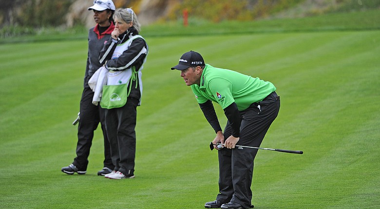 D.A. Points checks his line on the fifth hole at Pebble Beach Golf Links as Condoleezza Rice and her caddie watch Friday during the second round of the AT&T Pebble Beach National Pro-Am.