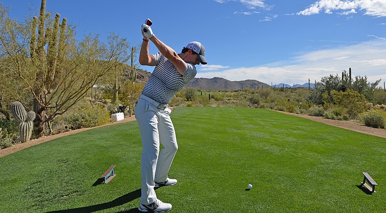 Rory McIlroy plays a shot during practice prior to the start of the WGC-Accenture Match Play at the Golf Club at Dove Mountain.
