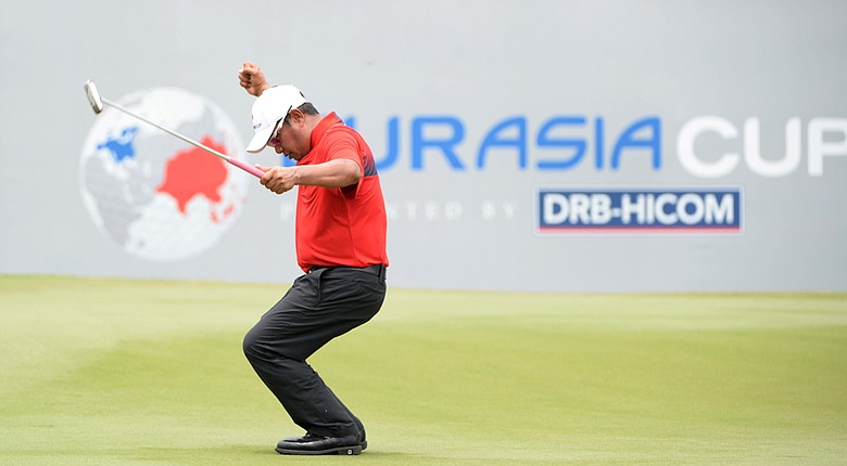 Pryad Marksaeng of Team Asia celebrates his putt on the 18th green during the single matches on Day 3 of the EurAsia Cup.