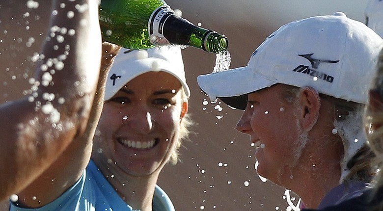 Karrie Webb, left, helps Stacy Lewis celebrate her 2011 Kraft Nabisco Championship win.
